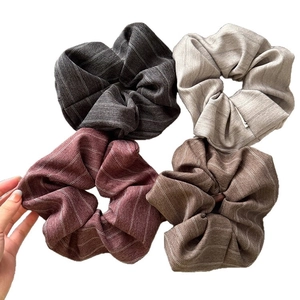Striped fabric scrunchies set in grey, beige, red, and coffee colors for women's hair