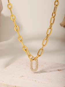 Macro shot of gold chunky link necklace with a sparkling oval pavé diamond pendant