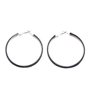 Fashionable denim fabric hoop earrings with silver pins on a white background