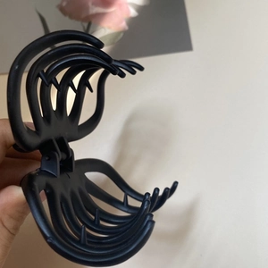 Detail shot of a large black plastic hair claw clip with a strong multi-tooth design