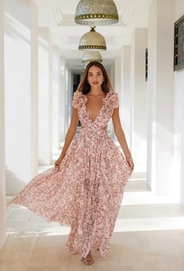 Detail view of deep V-neckline and hollow-out waist on pink floral maxi dress