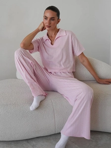 Pink knit two-piece set featuring short sleeve collared top and wide-leg trousers