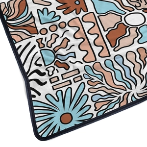 Close-up of soft flannel blanket with modern abstract print and reinforced blue hem