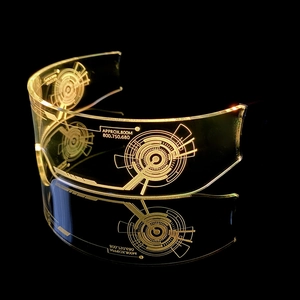 Macro view of cyberpunk LED glasses with golden illuminated etched circuit patterns