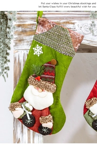 Detail of green knit Christmas stocking with a 3D Santa doll hanging on a white fireplace