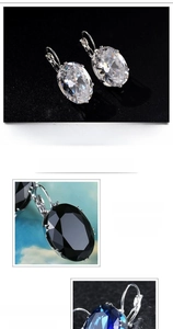 Detailed view of oval cut zircon earrings in white, black and blue gemstone colors