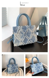 Detail view of denim tote bag featuring quilted texture and frayed edge fringe finish