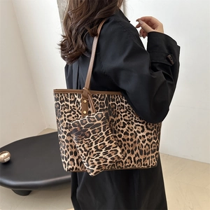 Leopard print canvas tote bag set with leather straps shown on model for autumn 2024
