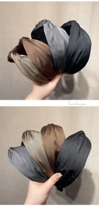 Close-up of pleated satin headbands in earth tones with stylish cross-knot detail