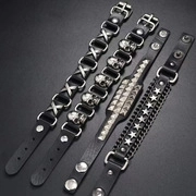 Detail of four black leather punk necklaces with silver bat and skull metal studs