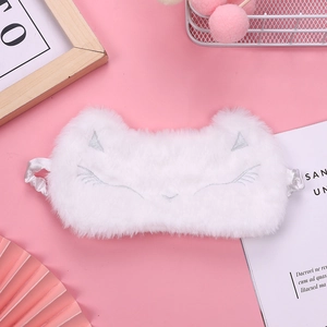 Detailed embroidery of cat ears and whiskers on a soft white plush sleep eye mask