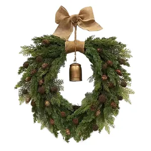 Christmas wreath with green pine branches, natural pinecones, burlap bow, and gold bell