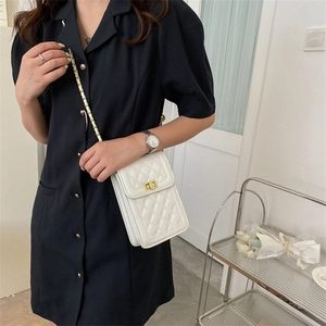 White quilted crossbody phone bag with gold chain strap and metal turn-lock closure