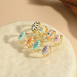 Detailed collection of gold evil eye rings with colorful enamel finishes on stone