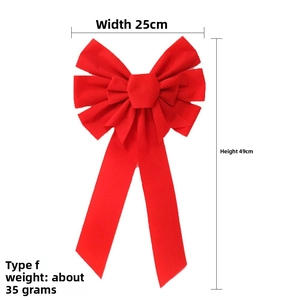 Detail view of large red velvet Christmas bow with size dimensions 25cm by 49cm
