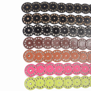 Detail view of round vintage leather studs with metallic eyelets in multi-color options