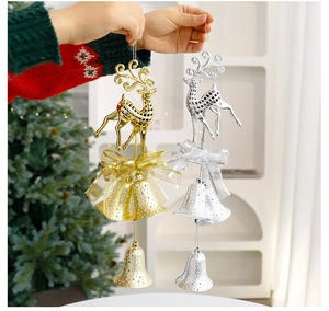 Detail of gold and silver reindeer Christmas bell ornaments with festive mesh bows