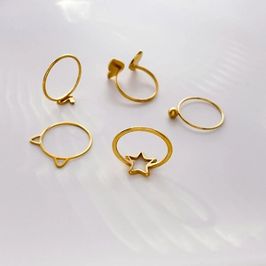 Set of five gold titanium steel rings featuring hollow star and bear ear geometric shapes