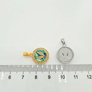 Macro detail of 18k gold butterfly pendant with shell inlay and honeycomb back design