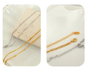 Detail of double-layer stainless steel snake and bead chains with secure lobster clasp