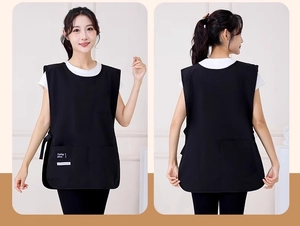 Detail of waterproof black apron vest featuring multiple utility pockets and reinforced seams