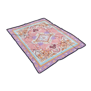 Detail view of woven flannel blanket with ethnic geometric patterns in soft pastel colors