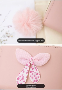 Close-up of pink leather wallet with soft pom-pom zipper and sweet polka dot mesh bow