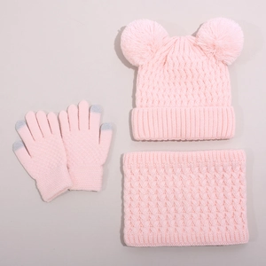 Detail of pink cable knit hat set featuring touchscreen gloves and dual pom-pom design