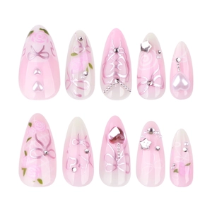 Pink gradient almond press-on nails with 3D stars, pearl bows, and floral designs