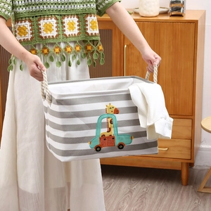 Detail of grey striped toy storage bin with cotton rope handles and giraffe embroidery