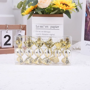 Set of 6 gold and white candy-shaped Christmas tree ornaments in a clear gift box