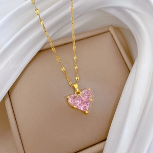 Luxurious gold titanium necklace with a pink heart zircon pendant on white silk