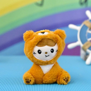 Close-up of a cute plush doll wearing a brown bear costume with soft fur texture.