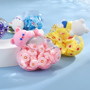 Close-up of cloud-shaped oil bottle keychains with cute bears and colorful flower charms