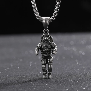 Close-up of a vintage astronaut pendant made of cast stainless steel with a silver-tone finish