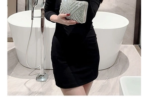 Silver rhinestone evening clutch bag with geometric patterns held by a model