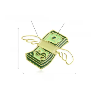 Creative flying dollar bill brooch with white wings and green enamel finish in gold frame
