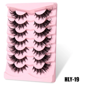 Detailed macro view of 7 pairs of thick DIY false eyelashes on a pink wavy display tray
