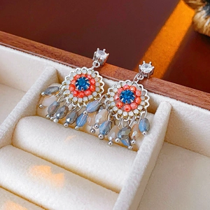 Vintage bohemian tassel earrings with blue stones and silver pins in a velvet jewelry box