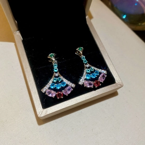 Detail view of fan-shaped ginkgo earrings with multi-colored cubic zirconia inlays