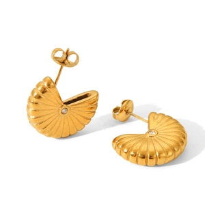 Close-up of golden shell stud earrings with radiating texture and a tiny diamond center