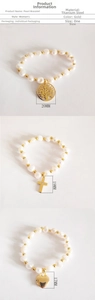 Detailed view of gold pearl bracelets with Tree of Life and cross pendants in titanium steel