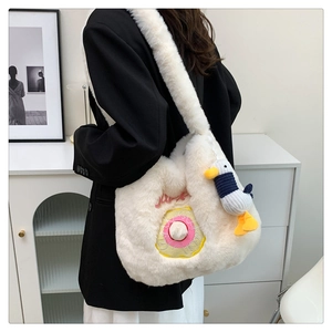 Detailed side view of beige plush crossbody bag featuring donut embroidery and duck charm
