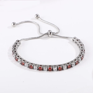 Adjustable silver bracelet featuring alternating red and white round cubic zirconia stones