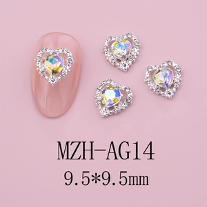 Macro shot of 9.5mm AB heart nail art charm with silver rhinestones on pink background