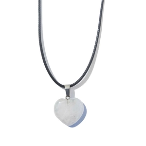 Macro view of a 20mm heart-shaped white opal stone pendant with black cord necklace