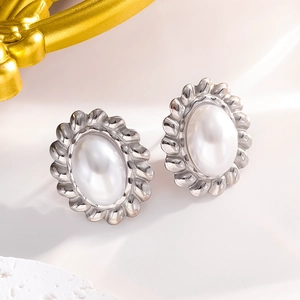 Close-up of white pearls set in silver twisted metal edges for elegant stud earrings