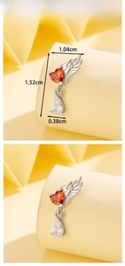 Detailed view of angel wing stud earring with red heart and pear-shaped crystals
