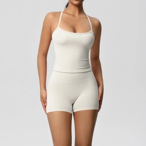 Detail view of cream white ribbed high-waist yoga shorts and strappy sports vest