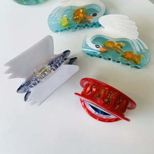Flat lay of star-shaped acetate hair claws in various translucent colors and patterns